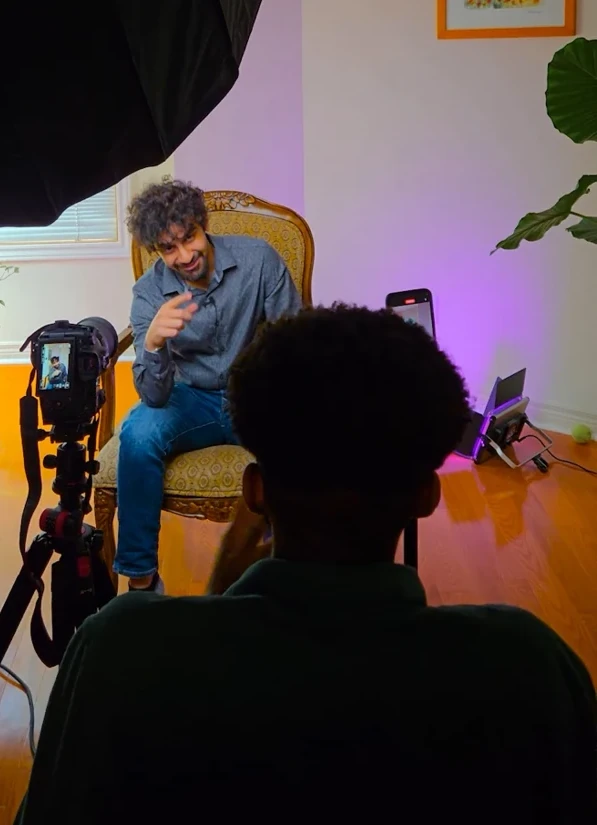 Dominic behind the camera during a seated interview